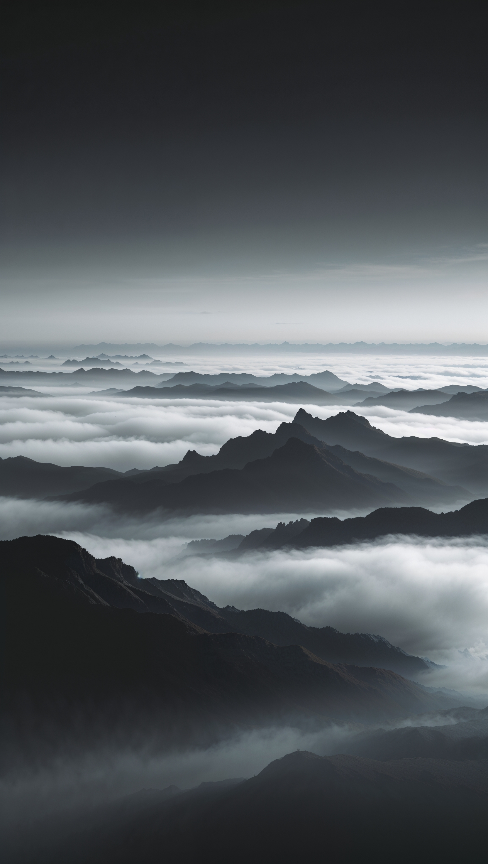 Mountain silhouette wallpaper in black and white with layered mist
