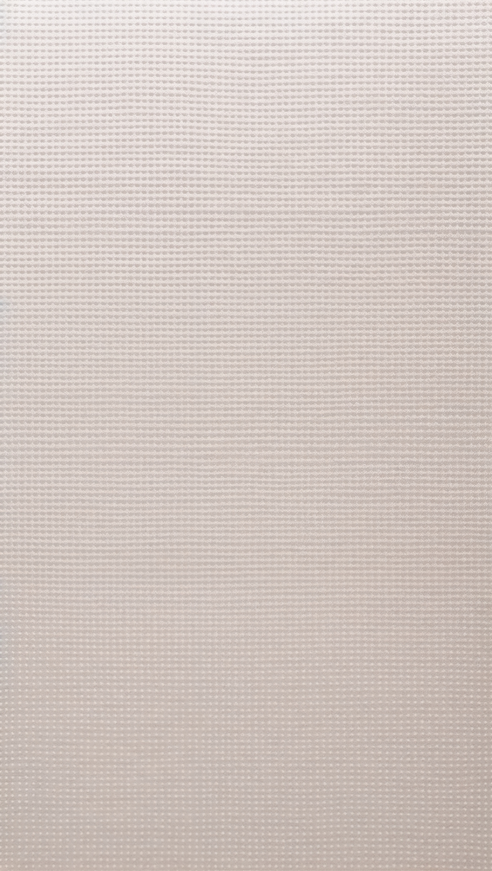 Repeating tiny dots pattern on soft cream background, minimal feel