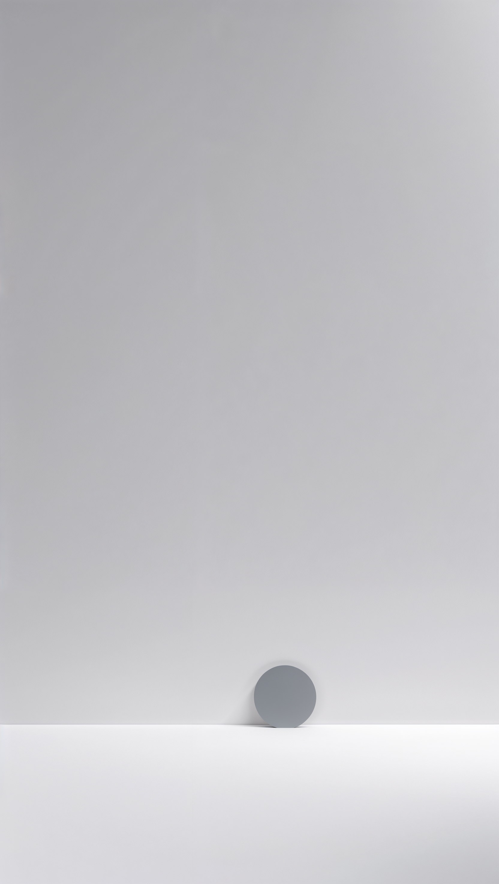 Pure white background with small gray circle in bottom right corner