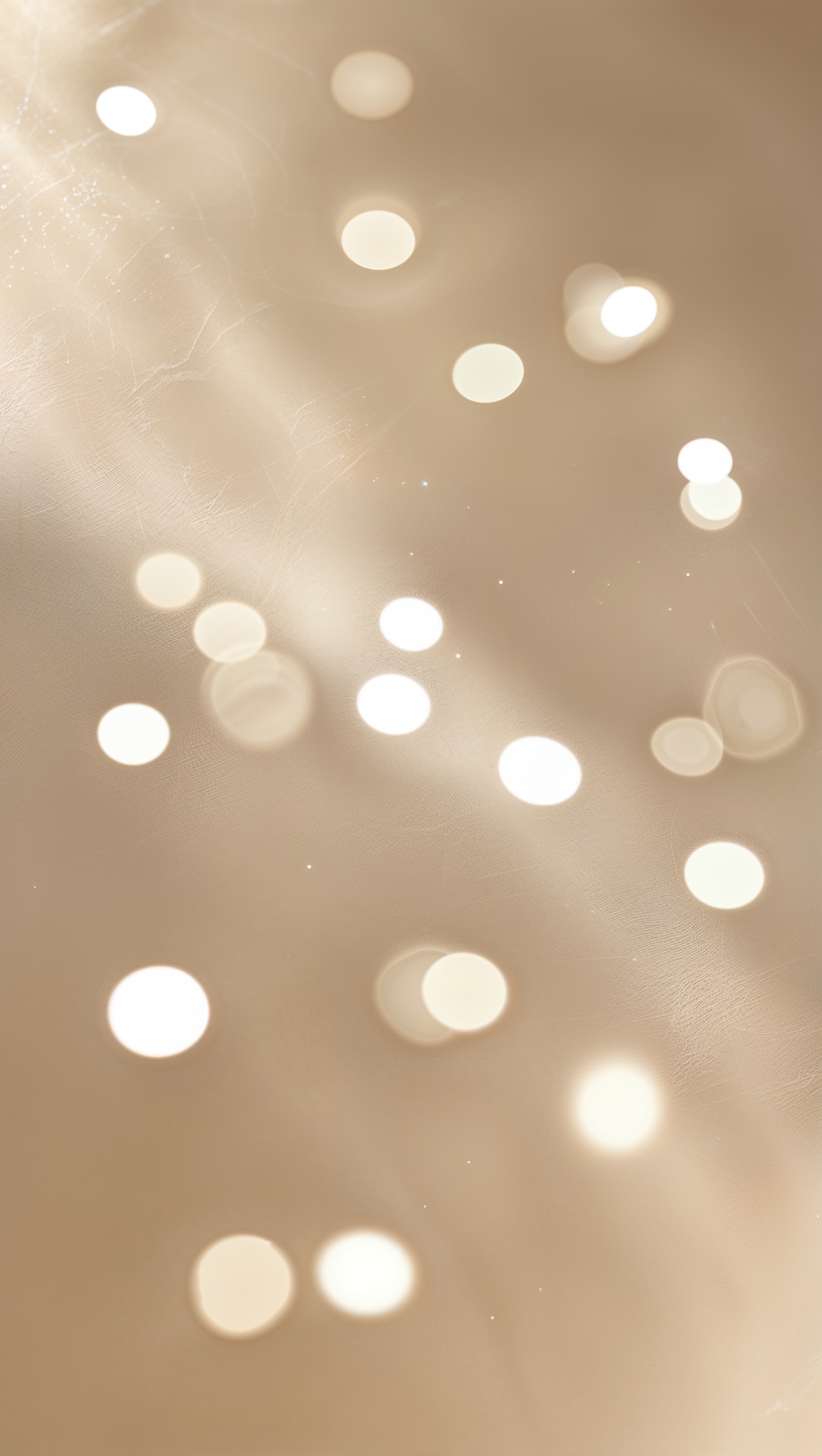 Blurred light spots on soft beige background for gentle glow effect