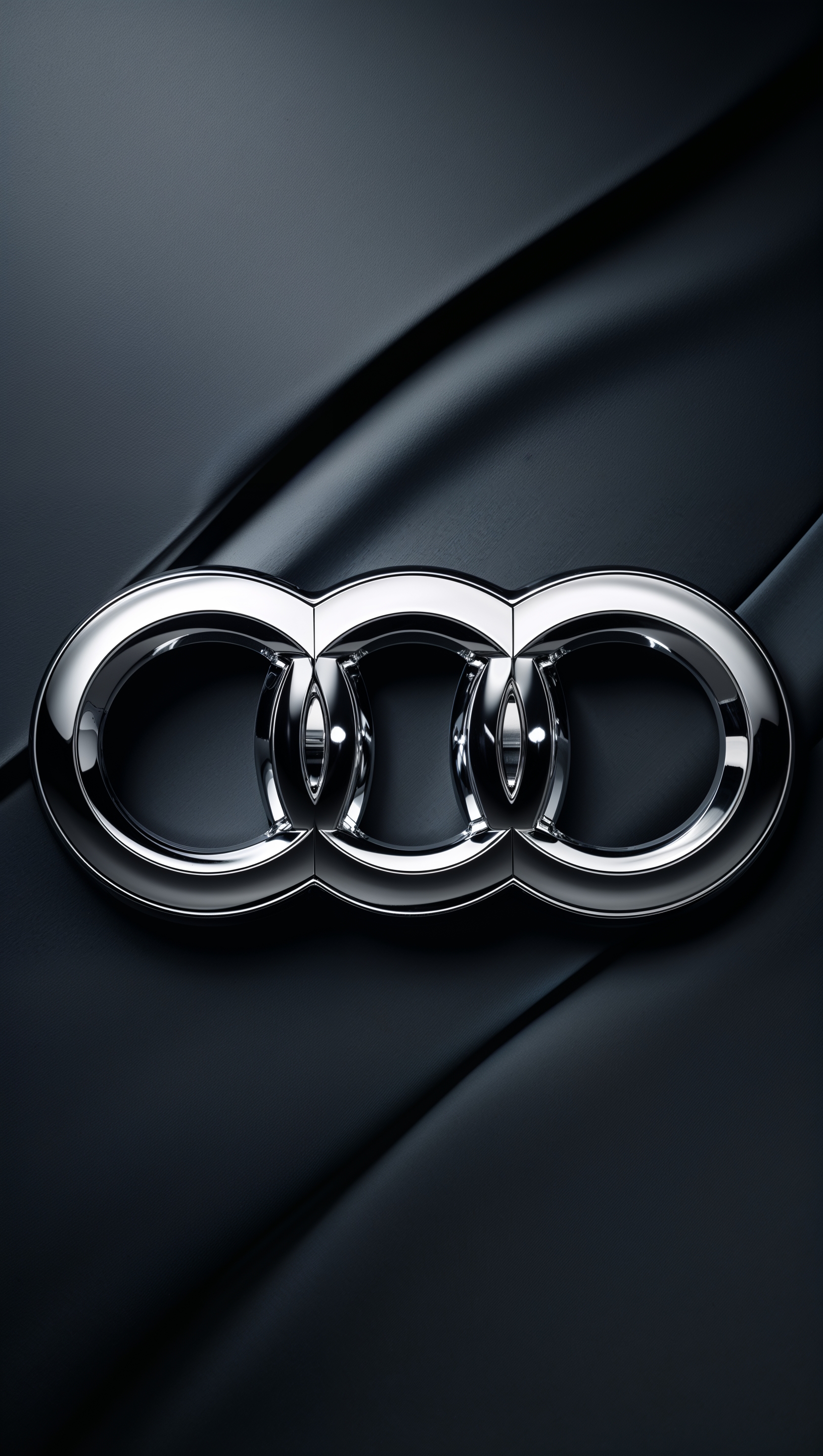 Shiny Audi logo on dark background for iPhone