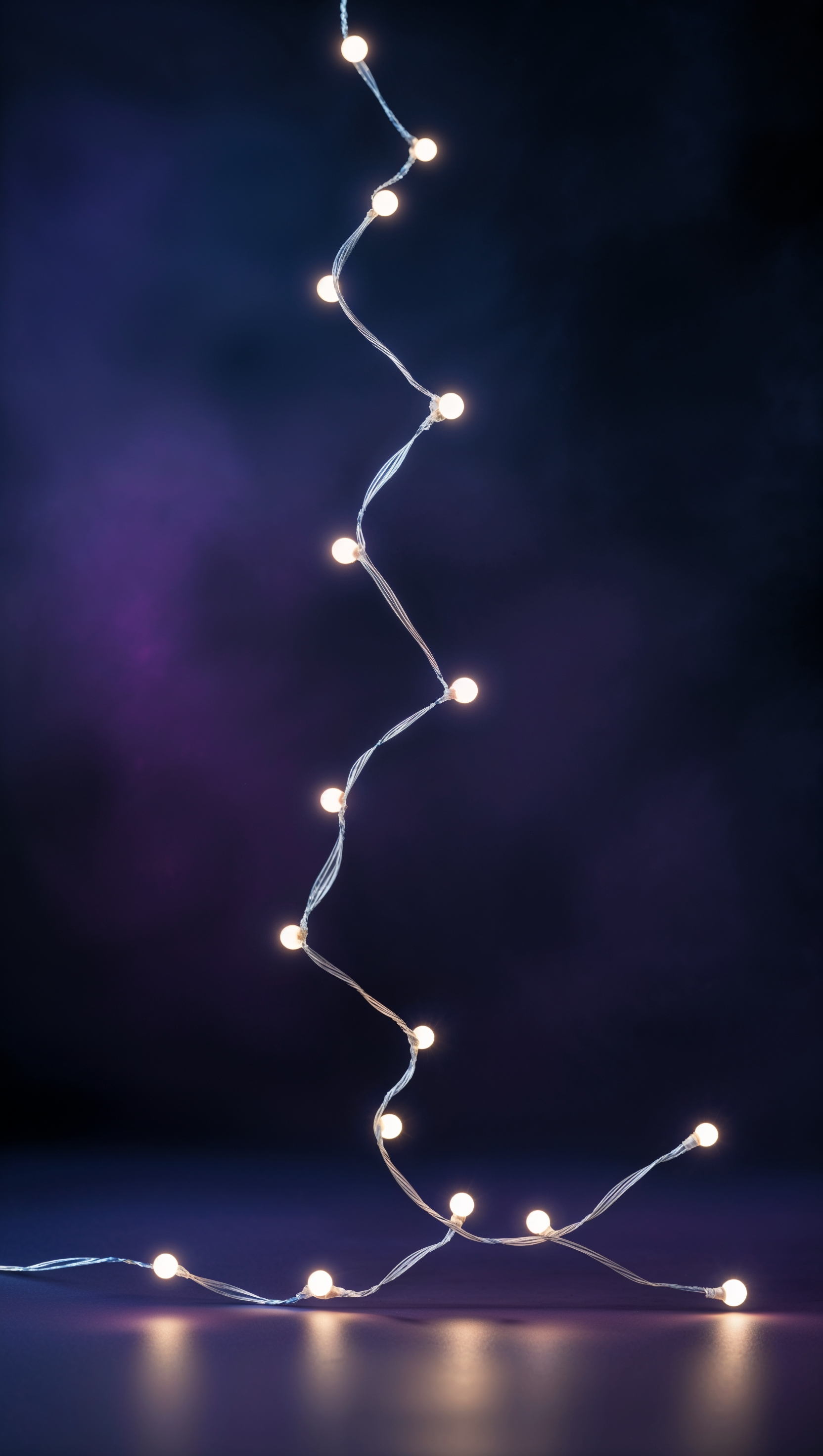 Dark background with a single white string of lights