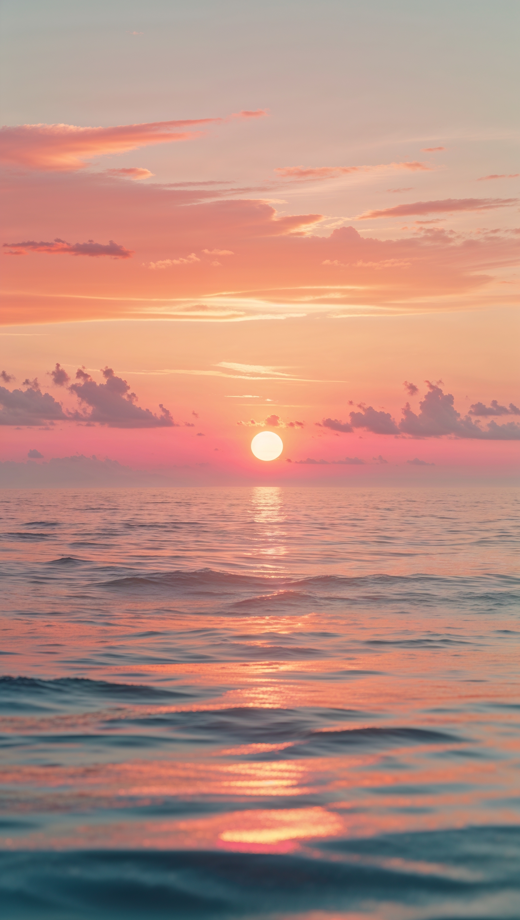 Peaceful sunrise over the ocean with orange and pink hues, perfect for iPhone wallpaper