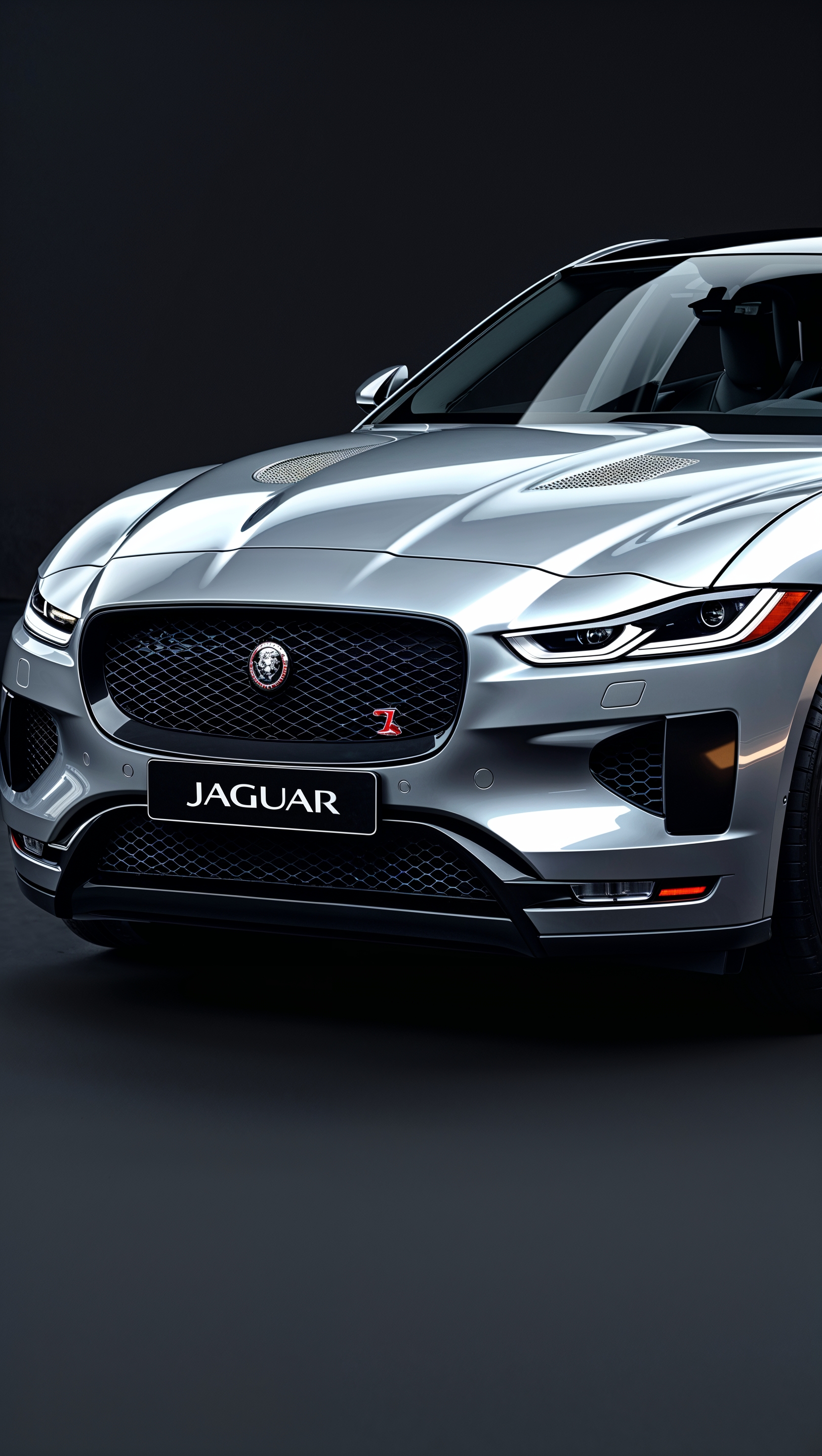 Front view of a modern Jaguar with matte black background