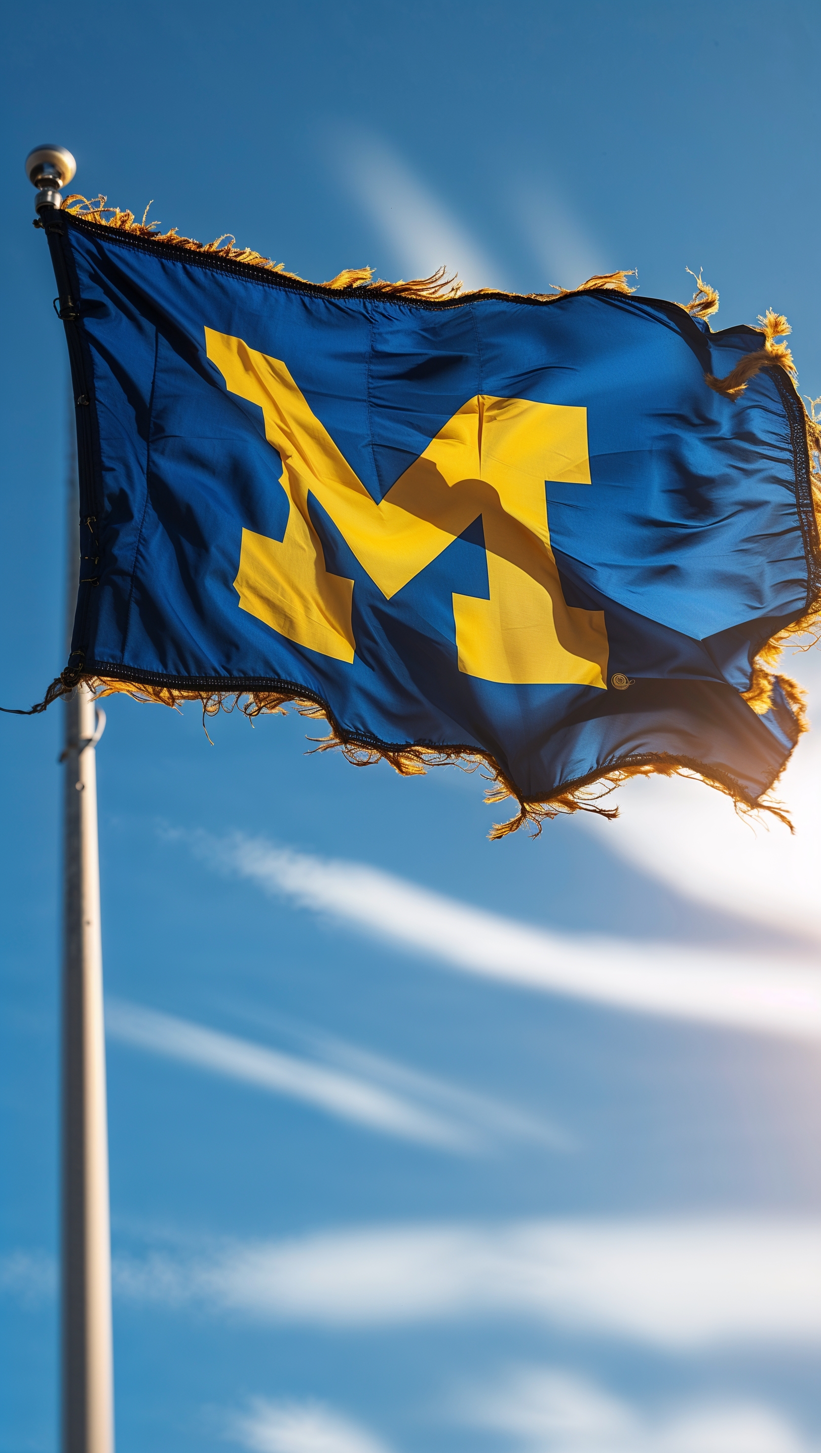 An image of Michigan football team flag waving in the wind
