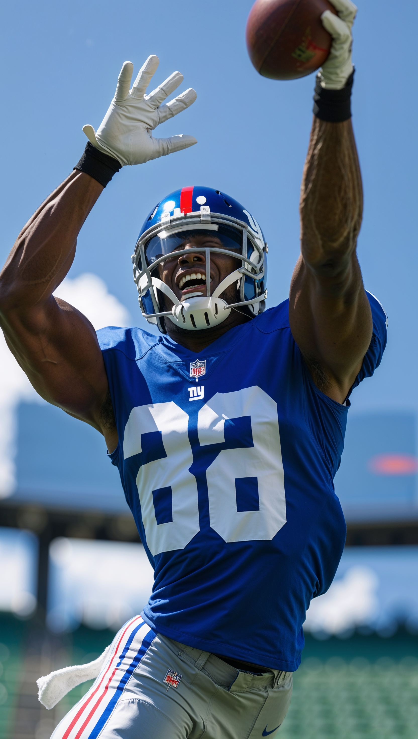 NY Giants player jumping to catch the ball